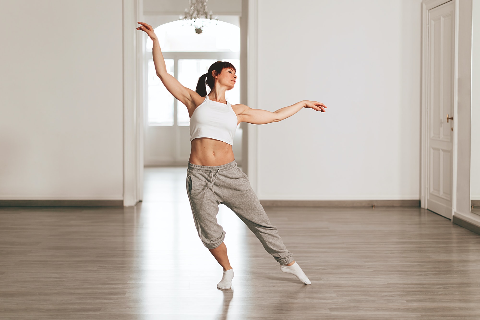 modern dance teacher rehearses the steps in the school by dancing elegantly